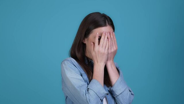 Candid lady playing hide palms face isolated blue color background