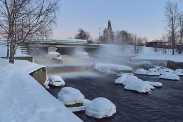 Dam and waterfall in winter: Sestroretsk, January, church, cold evening, before sunset.