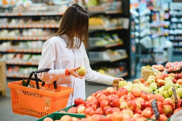 Casual woman grocery shopping and looking happy
