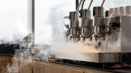 Barista is releasing steam from coffee machine