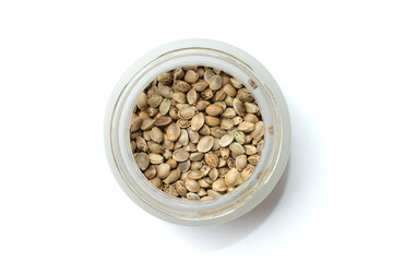 Hemp seeds, edible cannabis production. Marijuana grain in a round glass bowl on white background. Isolated
