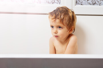 Handsome little boy portrait sit in the bath