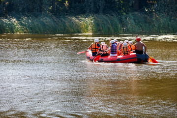 A group of tourists floats on an inflatable boat.