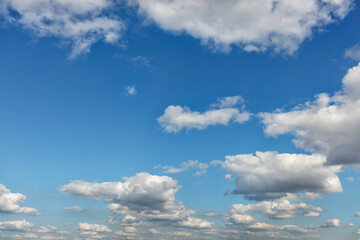 Small white clouds gradually fill the space in the blue sky.
