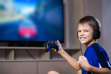 Young gamer playing online video games while streaming on social media. Blurred background and gamepad © Dyachenko