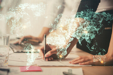 Double exposure of woman hands typing on computer and social network theme hologram drawing. People...