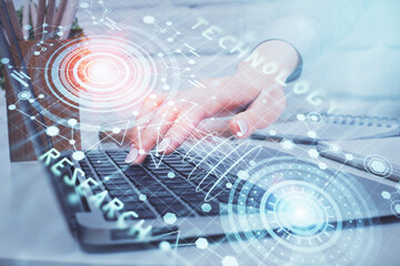 Double exposure of woman hands working on computer and data theme hologram drawing. Tech concept.