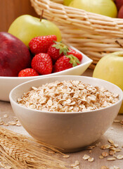 Oatmeal cereal bowl and ears of corns on fruit ingredients background.