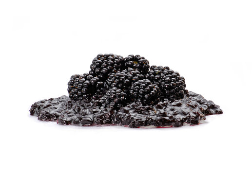 Blackberries on blackberry jam on white background.