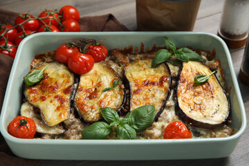 Delicious eggplant lasagna in baking dish on table, closeup