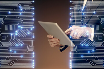 Double exposure of man's hands holding and using a digital device and tech theme hologram drawing....
