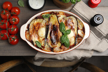 Delicious eggplant lasagna in baking dish on wooden table, top view