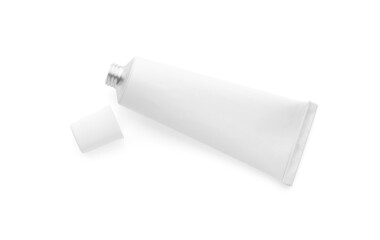Open tube of ointment on white background, top view