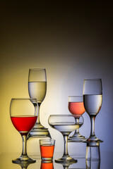 Glassware of different sizes against colorful background
