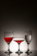 Glassware of different sizes against monochrome background