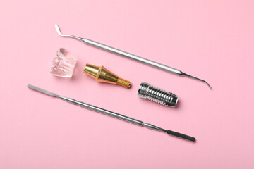 Parts of dental implant and medical tools on pink background, flat lay