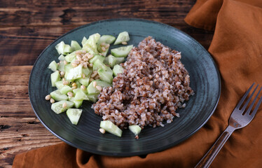 Boiled buckwheat and cucumbers with olive oil and pine nuts