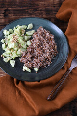 Boiled buckwheat and cucumbers with olive oil and pine nuts