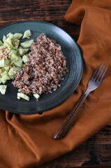 Boiled buckwheat and cucumbers with olive oil and pine nuts