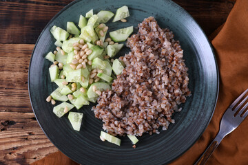 Boiled buckwheat and cucumbers with olive oil and pine nuts