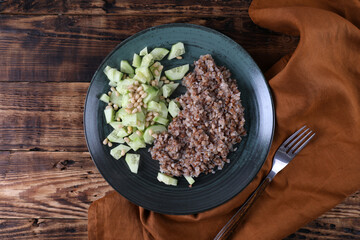Boiled buckwheat and cucumbers with olive oil and pine nuts