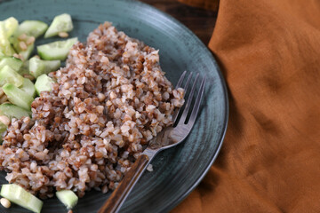 Boiled buckwheat and cucumbers with olive oil and pine nuts