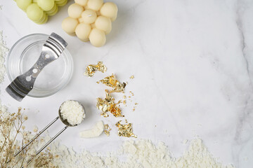 Tools and supply for candle-making: wicks, soy and coconut wax, gold foil, colors and aroma oils, bubble candle