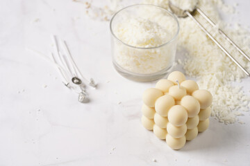 Tools and supply for candle-making: wicks, soy and coconut wax, gold foil, colors and aroma oils, bubble candle