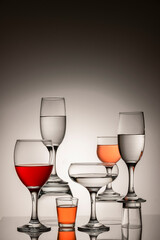 Glassware of different sizes against monochrome background