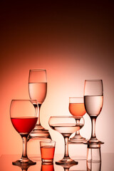Glassware of different sizes against colorful background