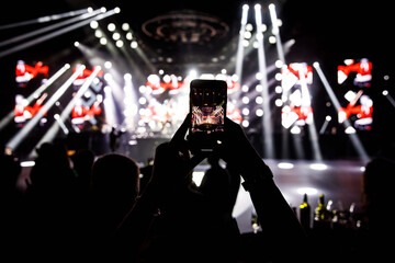 Making video recordings and pics on a smartphone at the concert or light show for publishing on...