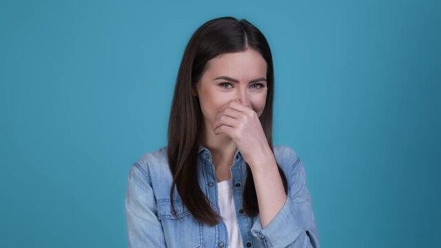 Lady not want her photograph hide face laugh isolated blue color background