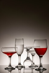 Glassware of different sizes against monochrome background