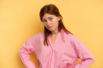 Fototapeta premium Young English woman isolated on yellow background confused, feels doubtful and unsure.