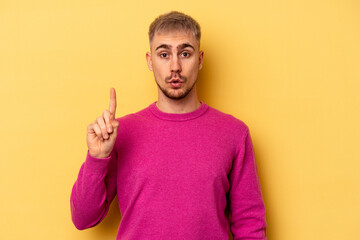 Young caucasian man isolated on yellow background having some great idea, concept of creativity.