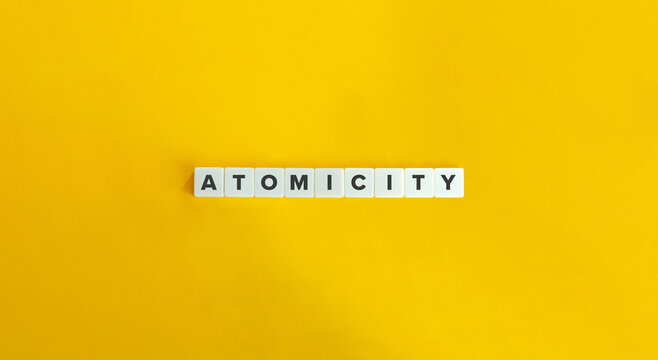 Atomicity Word, Banner and Concept. Letters tiles on bright orange background.