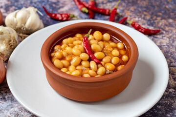 Hot turkish bean stew on wooden background. Ispir beans cooked in a casserole - Kuru Fasulye