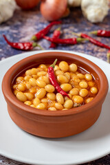 Hot turkish bean stew on wooden background. Ispir beans cooked in a casserole - Kuru Fasulye