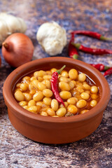 Hot turkish bean stew on wooden background. Ispir beans cooked in a casserole - Kuru Fasulye