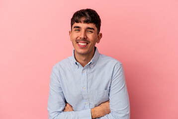 Young mixed race man isolated on pink background laughing and having fun.