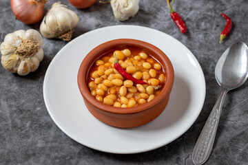 Hot turkish bean stew on dark background. Ispir beans cooked in a casserole - Kuru Fasulye