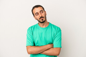 Young caucasian man isolated on white background dreaming of achieving goals and purposes