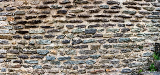 Fototapeten Big horizontal fragment of antique wall built of  flat stones © Mikhail Pankov