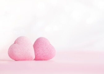 Valentines day greeting card , two  pink candy  hearts on gentle pink background  with  copy space .