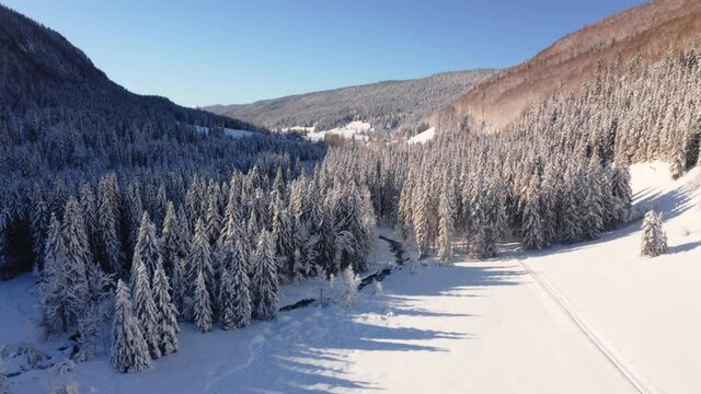 Survol drone de la vall&eacute;e de la Valserine, Jura, Mijoux. Paysage d&rsquo;hiver recouvert de neige, ciel bleu et beau temps.