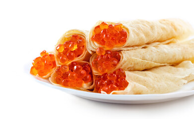 Traditional russian thin pancakes with large red salmon caviar on plate isolated at white background.