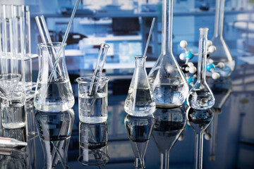 Laboratory investigations concerning test and medicine against covid. Microscope, glass tubes and beakers in the laboratory.