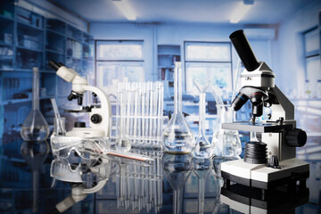 Laboratory investigations concerning test and medicine against covid. Microscope, glass tubes and beakers in the laboratory.
