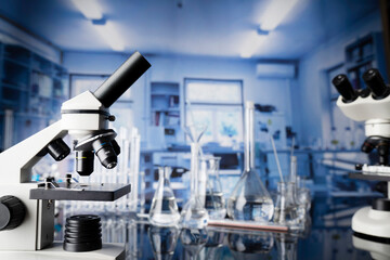 Laboratory investigations concerning test and medicine against covid. Microscope, glass tubes and beakers in the laboratory.