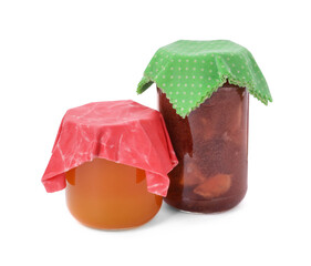 Jars of tasty jam covered with beeswax food wraps on white background